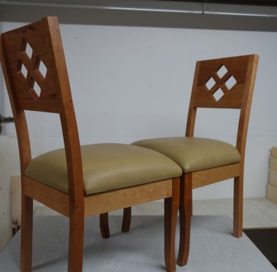 Two diamond chairs with light leather